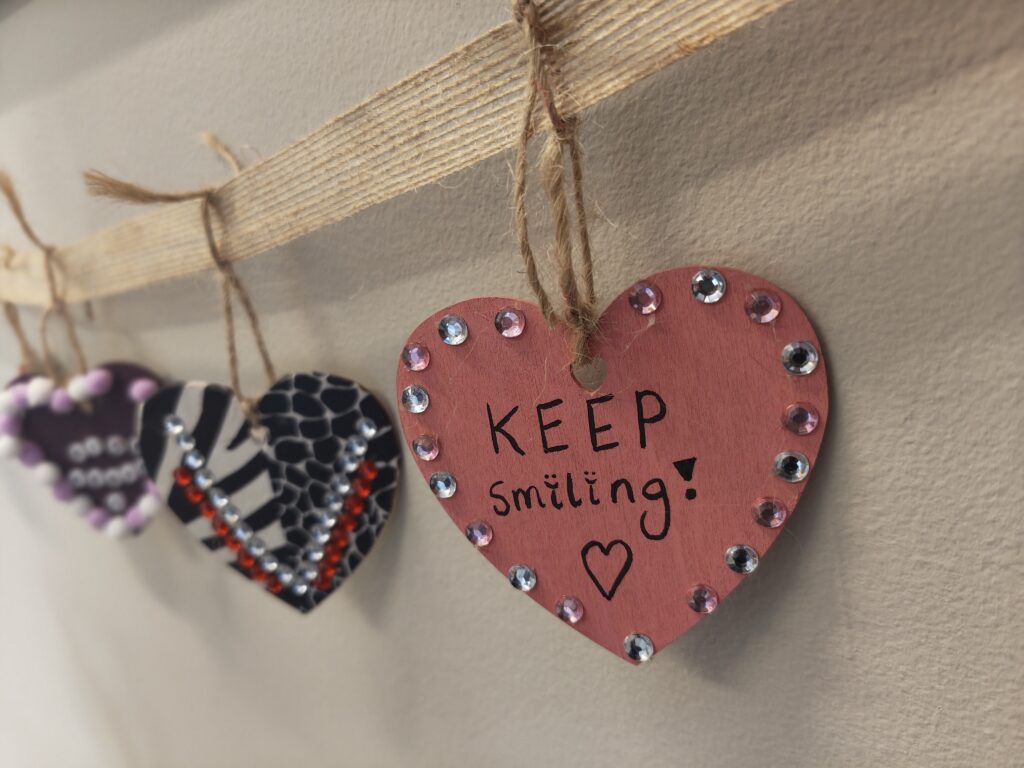 Heart decorated by service user reads 'keep smiling!'