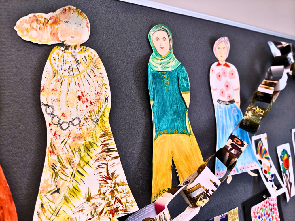Paper dolls decorated by service users